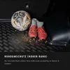 A dirty soccer ball and cleats are placed on a black car trunk liner. Produktbild-Vorschau