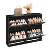 A black shoe cabinet filled with shoes, with a handbag and a vase of dried flowers on top. Produktbild-Vorschau