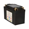 A black battery with gold terminals on a white background. Voir les images du produit