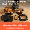 Kitchen counter with air fryer accessories and food. Produktbild-Vorschau