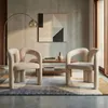 Two beige upholstered chairs in a modern living room setting. Voir les images du produit