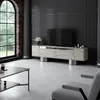 A modern living room with a TV stand, coffee table, and armchair. Voir les images du produit