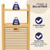 A close-up marketing image of a bamboo shelf unit with a laundry basket, highlighting its stability and storage capacity. Produktbild-Vorschau