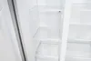 Interior of an empty refrigerator with clear shelves. Podgląd zdjęcia produktu