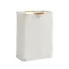 A white laundry basket with wooden handles against a white background. Náhľad obrázku produktu
