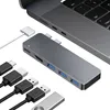 A USB-C hub and cables are arranged next to a laptop. Produktbild-Vorschau