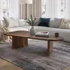 A living room scene featuring a modern wooden coffee table in front of a sectional sofa. Voir les images du produit