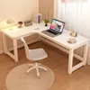 A white L-shaped desk with a laptop, lamp, and chair in a room with a window. Produktbild-Vorschau