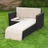 An outdoor lounge sofa with an extended chaise lounge, set on a grassy lawn with a large rock and foliage in the background. Podgląd zdjęcia produktu