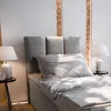 A bedroom scene with a bed, nightstand, and lamps. Produktbild-Vorschau