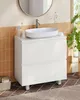 A white bathroom vanity with a sink and faucet, set against a tiled wall and floor. Voir les images du produit
