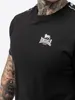 Close-up of a person wearing a black t-shirt with a white logo. Produktbild-Vorschau