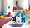 A cow-shaped nebulizer sits on a white table in a room filled with toys. Anteprima dell’immagine prodotto