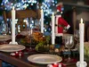 A Christmas dinner table setting with a roast chicken, plates, glasses, and LED candles. Anteprima dell’immagine prodotto