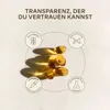 Several vitamin capsules are arranged on a textured light-colored surface, with circular diagrams highlighting product features around them. Produktbild-Vorschau