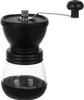A black and clear manual coffee grinder with a silver handle, shown against a white background. Náhľad obrázku produktu