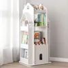 A white, castle-shaped bookshelf filled with books and toys, placed indoors near a window with sheer curtains. Produktbild-Vorschau