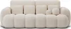 A cream-colored, three-seater sofa with a ribbed texture and multiple cushions. Produktbild-Vorschau