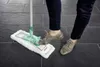 A person is using a Leifheit floor wiper on a tiled floor. Produktbild-Vorschau