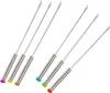 A set of six raclette grill forks with colored handles, arranged diagonally on a white background. Produktbild-Vorschau