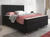 A black king-size box spring bed with patterned bedding and pillows. Produktbild-Vorschau