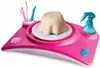 A pink pottery studio toy set with clay on a turntable, tools, and a spray bottle. Produktbild-Vorschau