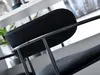 Close-up view of the backrest and seat of a black bar stool. Produktbild-Vorschau