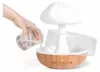 A hand is pouring water into a mushroom-shaped humidifier. Náhled obrázku produktu