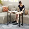A woman is sitting on a sofa and reading a book next to a small table with wheels. Anteprima dell’immagine prodotto