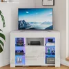 A white, glossy corner TV stand with LED lighting, displaying various items on its shelves. Voir les images du produit