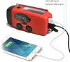 A red emergency radio is shown charging a smartphone, with text labels indicating its input and output ports. Produktbild-Vorschau