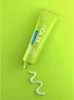 A tube of toothpaste is shown on a bright green background with a swirl of toothpaste on the surface. Anteprima dell’immagine prodotto