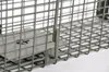 A close-up view of a metal animal trap. Produktbild-Vorschau