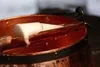 A close-up view of a white object resting inside a copper pot. Produktbild-Vorschau