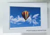 The image shows the packaging of a portable monitor with a picture of a hot air balloon on the screen. Produktbild-Vorschau