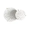 Two round tables with a terrazzo-like pattern are shown from a top-down view. Voir les images du produit