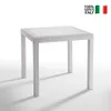 A white square table with a rattan-like texture, shown in a studio setting with a white background and shadows. Produktbild-Vorschau
