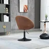 A brown fabric swivel chair with a black base is placed on a light blue and white rug next to a grey bookshelf and a small black table with a vase. Produktbild-Vorschau