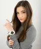 A woman wearing a grey turtleneck sweater and a white Casio G-Shock watch. Produktbild-Vorschau