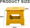 A yellow folding stool with product dimensions indicated by measurement lines and text. Produktbild-Vorschau