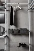 A closet system with hanging clothes and storage baskets. Produktbild-Vorschau