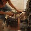 A person is loading dishes into a dishwasher. Podgląd zdjęcia produktu