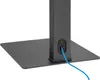 A close-up view of the base and lower part of a black TV stand, showing a cable management port with a blue cable inserted. Náhľad obrázku produktu