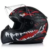 A black motorcycle helmet with a red and white monster graphic design, shown from the side. Produktbild-Vorschau