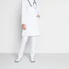 A person wearing a white doctor's coat and white pants, with a stethoscope around their neck, standing against a white background. Náhľad obrázku produktu