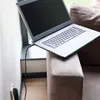 A laptop is plugged into a wall outlet and placed on a sofa near a window. Voir les images du produit