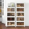 Two stacks of white storage boxes with clear fronts, filled with books and other items, are placed against a white wall. Náhled obrázku produktu