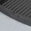 A close-up view of the edge of a black cast iron grill pan, showing the ribbed surface and the texture of the material. Náhľad obrázku produktu