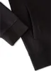 A close-up view of a black garment, likely a hoodie or jacket, showing a pocket and sleeve cuff. Produktbild-Vorschau