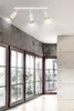 A modern interior with large windows and a track light fixture. Podgląd zdjęcia produktu